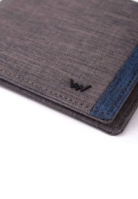 Gray fabric wallet featuring a textured surface, dark blue accent, and a small black logo on the front. Clean, minimalist design.