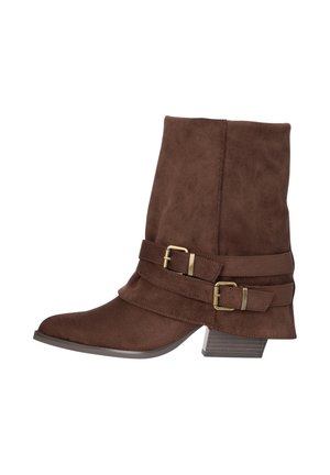 Bottine en daim brun avec un petit talon empilé, un bout pointu et deux sangles décoratives à boucle dorée sur le côté.