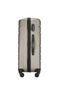 Hard-shell suitcase in metallic silver, featuring a textured surface, black zipper, handle, and four black wheels for mobility.