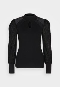 Haut noir à manches longues avec corps côtelé, manches bouffantes en dentelle transparente, col montant et découpe en trou de serrure sous le col.