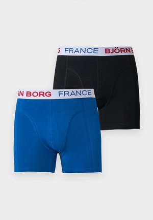Deux paires de boxers, un bleu et un noir, chacun avec une ceinture blanche comportant "BJÖRN BORG" et "FRANCE" en texte rouge et bleu.