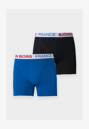 Deux paires de boxers, un bleu et un noir, chacun avec une ceinture blanche comportant "BJÖRN BORG" et "FRANCE" en texte rouge et bleu.