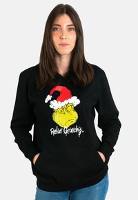 Felpa nera con una grafica frontale del Grinch in un cappello di Babbo Natale rosso e bianco, con la scritta "Sentendosi Grinch" sotto il design.