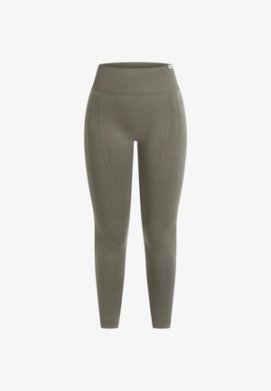 Leggings vert olive en tissu extensible avec une taille haute et des panneaux latéraux texturés. Forme ajustée avec une finition lisse.