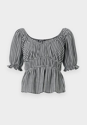 Blouse à carreaux noir et blanc avec des manches courtes bouffantes, un décolleté carré et une taille froncée, présentant un design peplum et des accents volants.