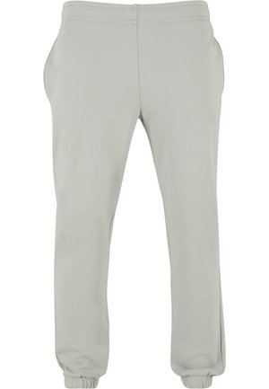 Lichtgrijze joggingsbroek met een elastische tailleband, zijzakken en elastische manchetten bij de enkels. Gemaakt van zachte, rekbare stof.