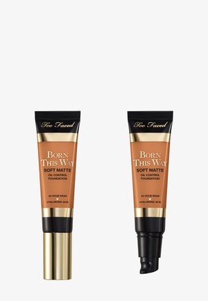 Deux tubes de fond de teint de Too Faced, avec une finition mate. Celui de gauche a un capuchon doré ; celui de droite a une pompe noire. Les deux sont dans un emballage marron.
