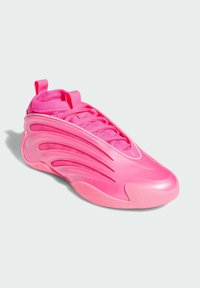Bright pink modern sneaker with a sleek design, ribbed sole, lace-up front, and pull tabs on tongue and heel against a white background.