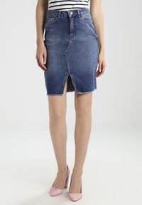 Denim kokerrok in medium blauw, met een voorkeursplit en een rafelige zoom. Hoge taille met vijf zakken en een knoopsluiting.