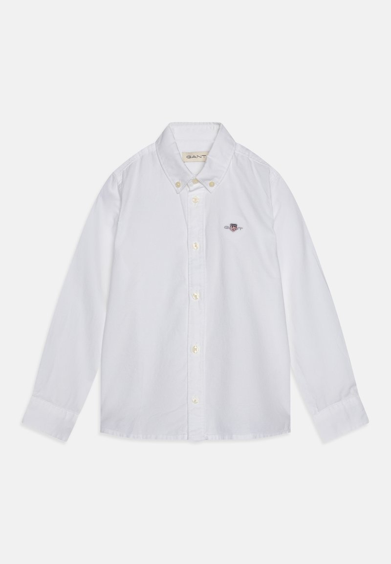 Chemise blanche en coton à manches longues avec col à boutons, dotée d'un petit logo brodé sur la poitrine et d'une fermeture à boutons.
