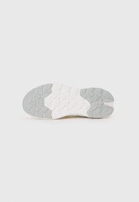 Shoe sole with a textured design; features a split shape. Color gradient from grey to white. Grooved tread pattern for traction.