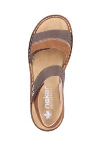Brown leather sandal with two wide straps, a cushioned insole, and white stitching. Features "Rieker Antistress" branding on the footbed.