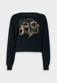 Černá zkrácená mikina s designem hada z flitrů v zlaté a zelené barvě, s kulatým výstřihem a dlouhými rukávy. Hladká textura.