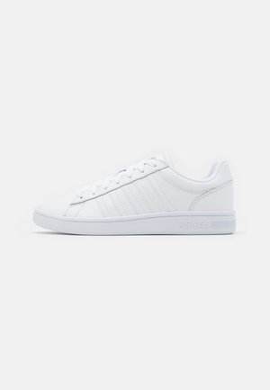 Witte lage sneaker met witte veters, vijf gestikte zijstrepen en geperst "K-SWISS" op de zool, weergegeven in zijaanzicht rechts.