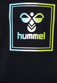 Czarny materiał z grafiką w motyw pszczoły w gradientowych kolorach niebieskim i zielonym, oprawiony kwadratowym konturem. Pod grafiką znajduje się słowo "hummel".