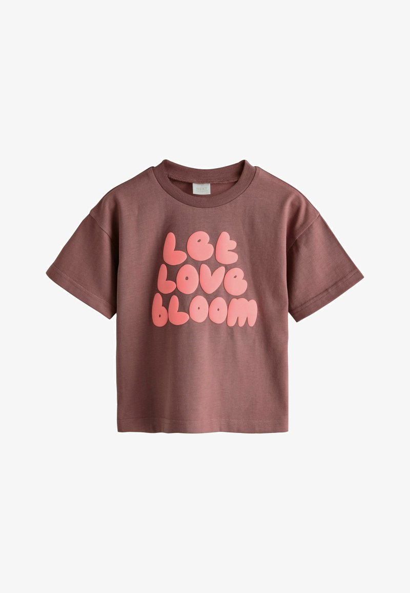 T-shirt mauve à manches courtes avec un col arrondi et des lettres bulles roses indiquant « Let Love Bloom » à l'avant.