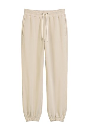 Beige sweatpants made of soft fabric, featuring an elastic waistband with drawstring, side pockets, and elastic cuffs at the ankles.