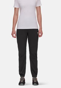 Schwarze, leichte Hosen mit schmaler Passform und elastischen Bündchen, die über schräg verlaufende Nähte und ein Logopatch auf der Vorderseite verfügen.