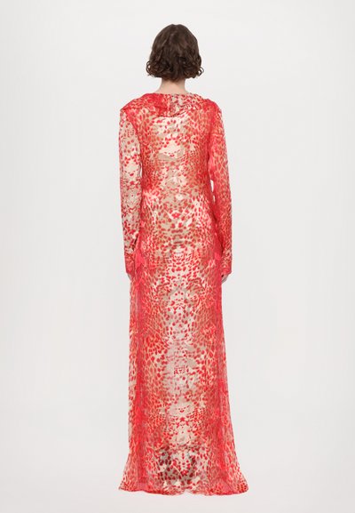 Long, sheer dress with a red and beige animal print. Features long sleeves and a flowing design, showcasing a layered texture.