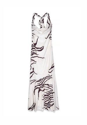 White halter-neck maxi dress with black abstract zebra stripes and a tie closure at the neck, featuring a flared bottom hem.