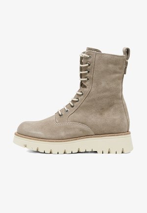 Beige suede ankle boot with a rounded toe, lace-up front, metal eyelets, and a textured white rubber sole featuring a rugged tread pattern.