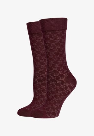 Chaussettes bordeaux à motif avec une finition texturée, présentant un revers côtelé et un design géométrique sur l'ensemble du corps.