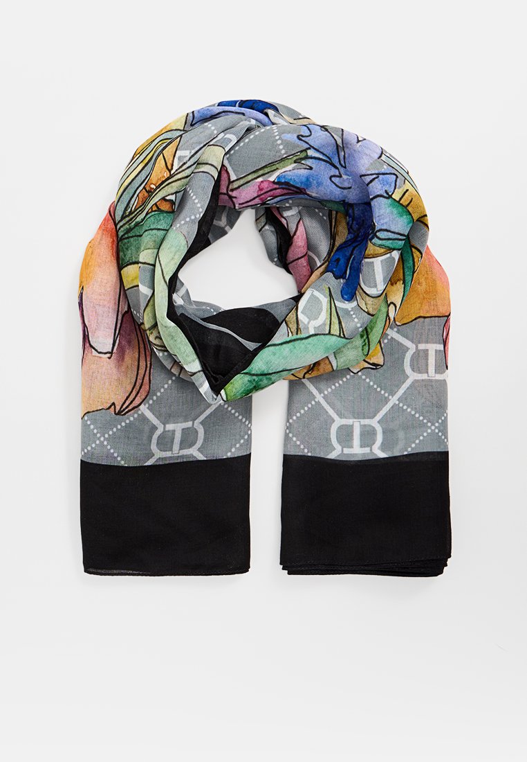 Lekki jedwabny szalik z kolorowymi wzorami kwiatowymi na szarym tle z czarnymi brzegami. Widać abstrakcyjne wzory i tekstury.