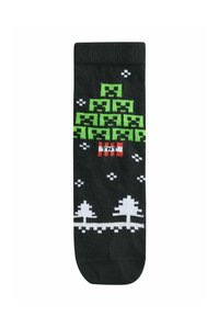 Schwarze Socken mit einem grün pixelierten Weihnachtsbaumdesign, roten Akzenten und weißen Schneeflocken und Bäumen, die an der Basis gedruckt sind.