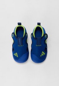 Blue mesh water shoes with neon green accents, rounded toe, and pull tabs. Textured upper for ventilation, flexible rubber sole for grip.