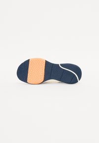Shoe sole with a textured navy blue design, featuring an orange rubber patch and a curved white section at the front.