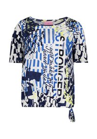 Loose-fitting, short-sleeve top in white with blue and yellow abstract patterns. Features a knotted side detail and bold text.