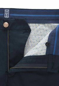 Navy blue pants with partially unzipped zipper, button closure, patterned inner lining, and branded size label M5 by Meyer.