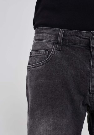 Black denim jeans featuring a straight leg design, subtle faded texture, front pocket, and a classic button and zipper closure.