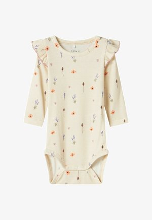 Cream ribbed long-sleeve baby bodysuit with floral patterns, ruffled shoulder detail, snap closure at the bottom, and soft texture.