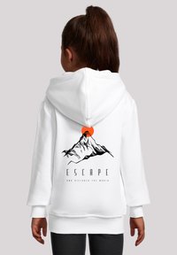 White hooded sweatshirt with a mountain graphic and orange sun on the back. Features ribbed cuffs and a relaxed fit.