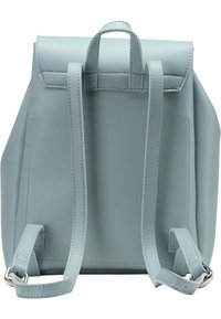 Sac à dos en cuir bleu clair avec une forme structurée, fermeture par rabat supérieur, bretelles ajustables et finition texturée subtile.