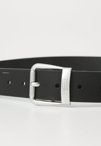 Black leather belt with a silver metal buckle, featuring several holes for adjustment and a textured finish near the buckle.