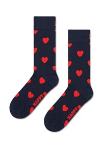 Chaussettes navy avec un motif de cœurs rouges. Elles présentent un ourlet côtelé et le mot "HAPPY" en rouge en bas.