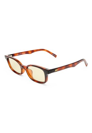 Rectangular tortoiseshell eyeglasses with light yellow lenses and slim arms featuring a small gold emblem on the side.