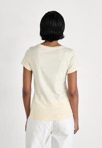 Calvin Klein Jeans MONOLOGO V NECK TEE - Triko s potiskem - vanilla