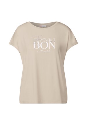 Beige t-shirt med kort ärm i mjukt material, med en vittryckt design med texten "BON" och "bra saker står" i en avslappnad stil.