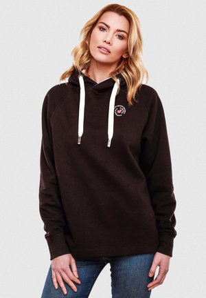 Black hooded sweatshirt with white drawstrings, featuring a small circular logo on the chest. Soft texture, relaxed fit, ribbed cuffs.