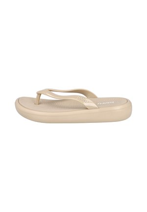 Chancla beige con suela gruesa, tiras curvas y plantilla texturizada, vista de lado.