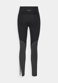Mustat urheilulegginsit, joissa on korkea vyötärö, harmaat paneelikoristelut ja raidallinen yksityiskohta helmassa. Valmistettu joustavasta materiaalista.