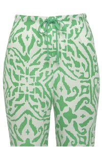 Grüne gemusterte Jogginghose mit einem Kordelzugbund, aus weichem Stoff mit einem strukturierten abstrakten Design auf heller Hintergrund.