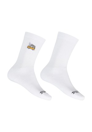 White crew socks with a small embroidered yellow camper van on one and black text on the toes on a white background.