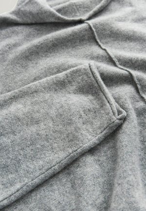 Gray woolen pullover with a relaxed shape, featuring a rounded neckline, visible stitching, and soft, textured fabric.