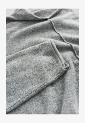 Gray woolen pullover with a relaxed shape, featuring a rounded neckline, visible stitching, and soft, textured fabric.