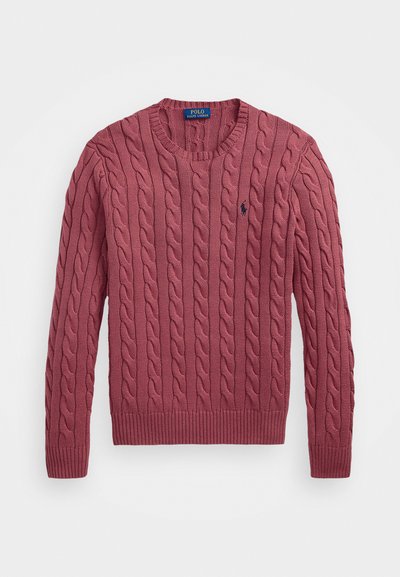 Cable-knit sweater in rose color, featuring a ribbed neckline, cuffs, and hem, with a small logo on the chest. Soft texture and classic design.