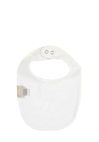 White cotton bib with a rounded shape, featuring a neck cutout and two snap closures. Soft texture with a small tag on the side.